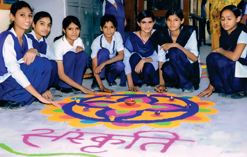 Students making a rangoli during an art competition