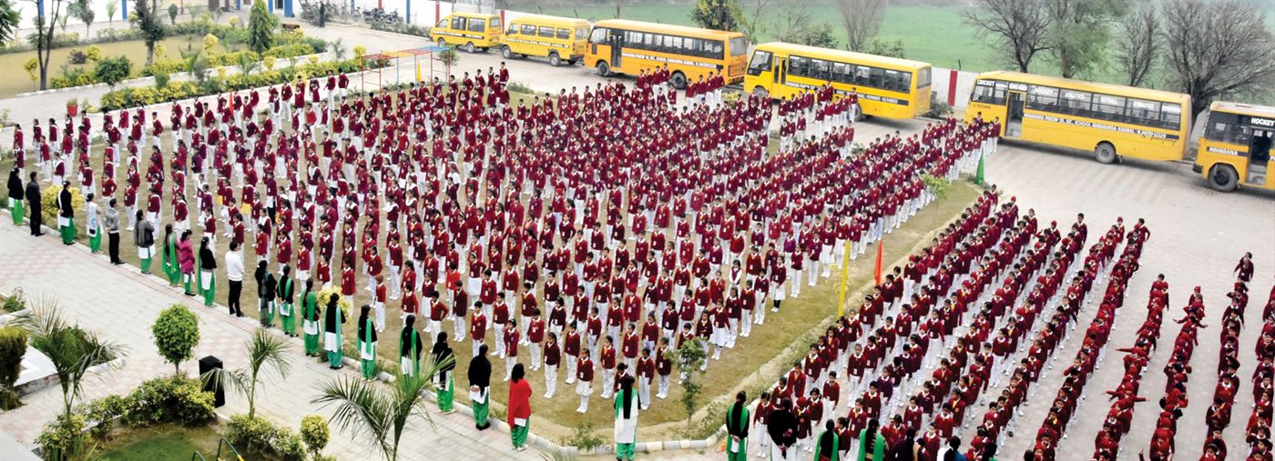 Morning assembly with the school bus fleet behind